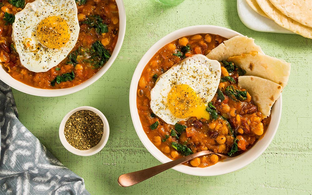Middle Eastern Fasoulia Stew with beans, flatbread and a fried egg,